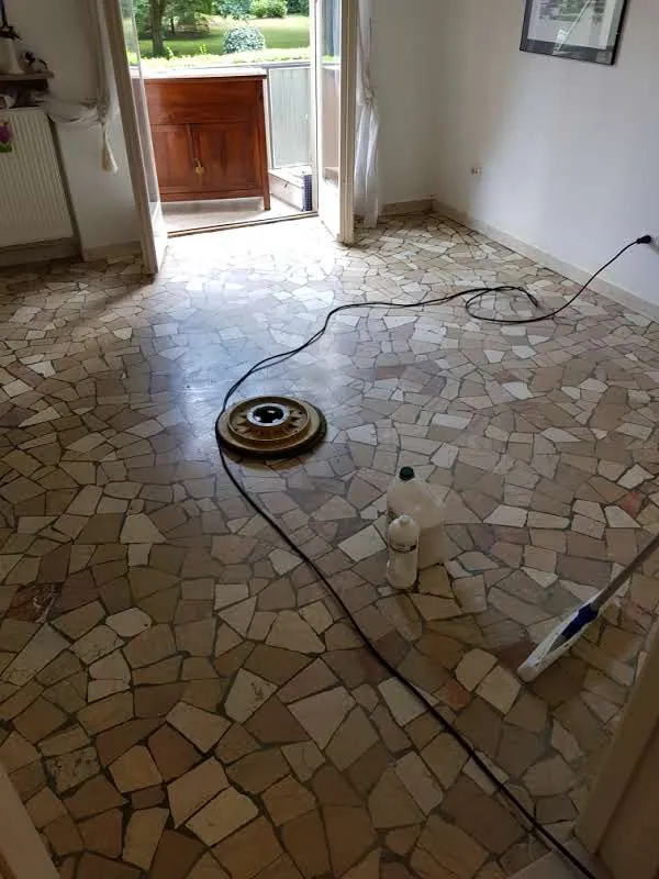 Dull crazy-paving marble floor, with the floor machine at work